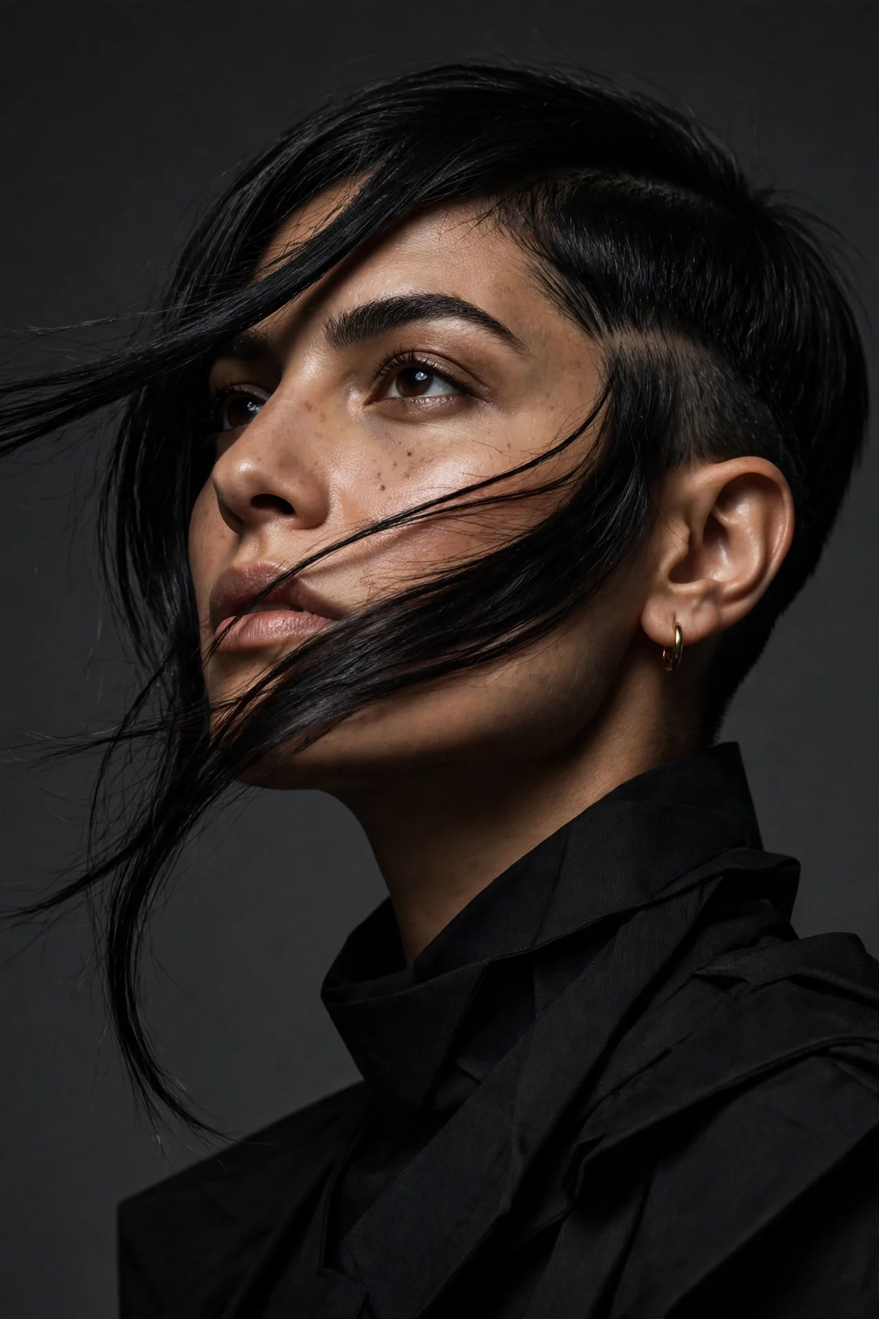 Asymmetrical bixie cut with one longer side on a Middle Eastern woman