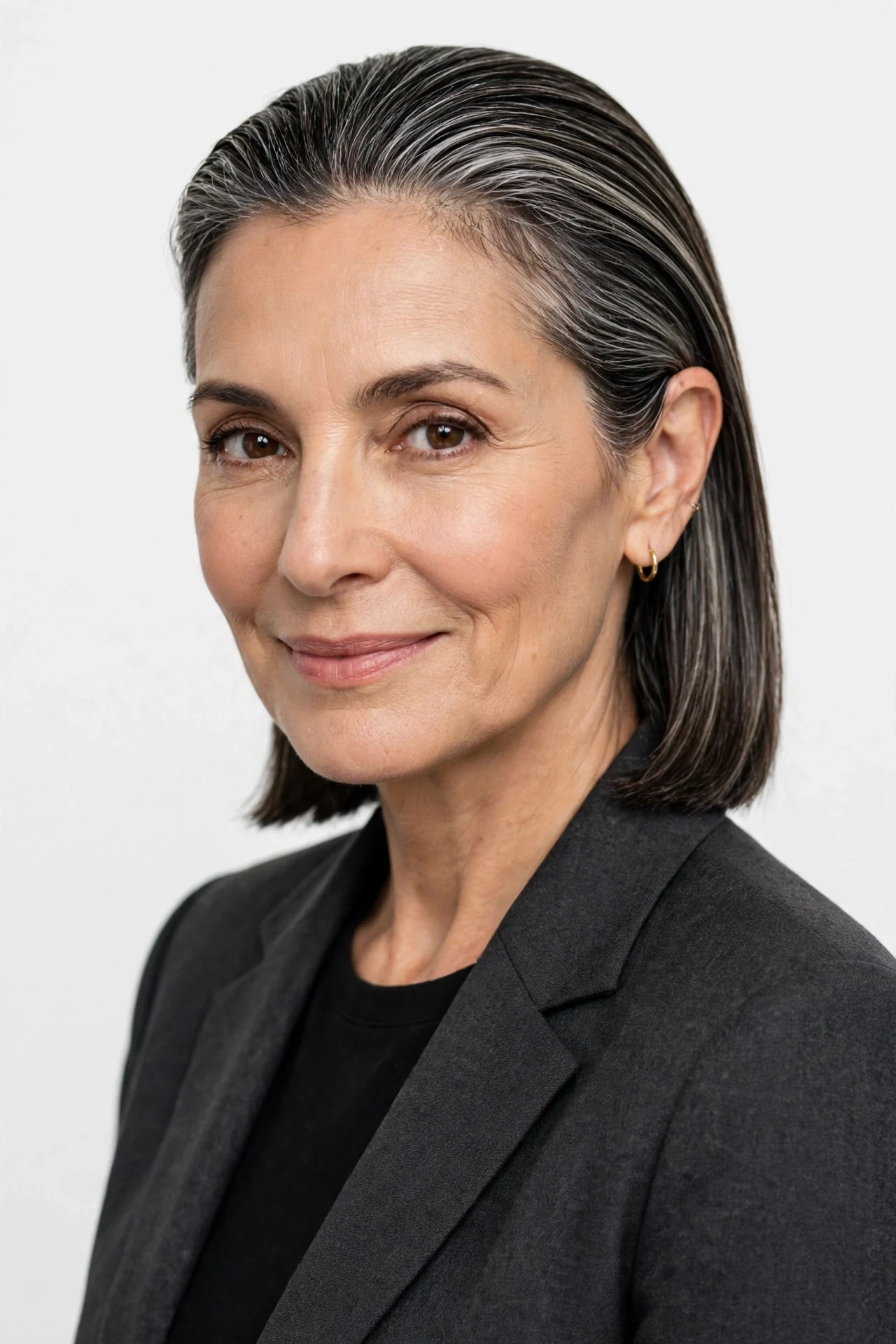 Sleek straight neck length hair tucked neatly behind one ear