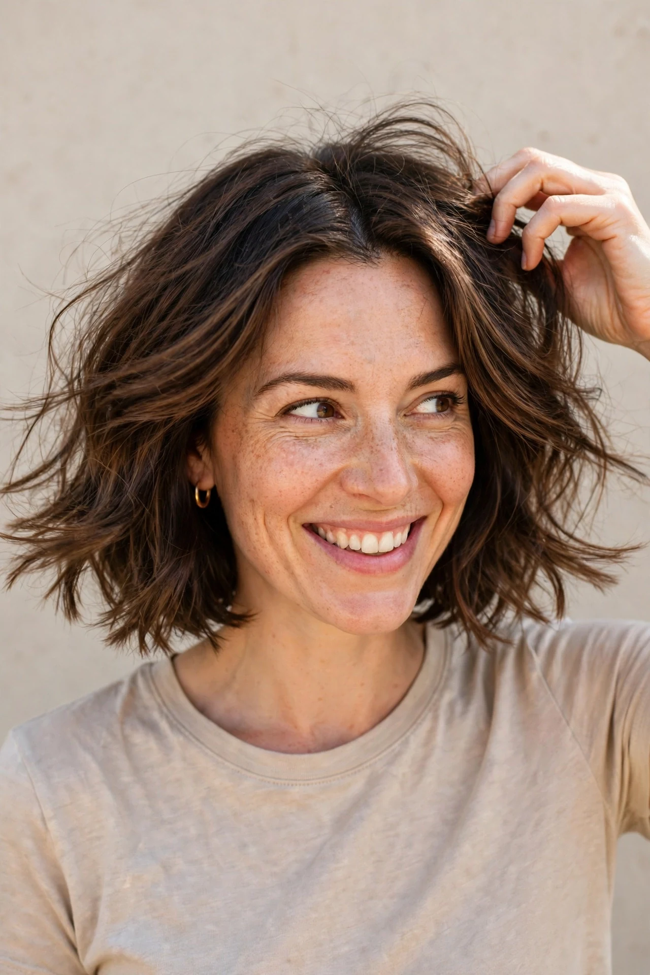 Woman with a growing out bob whose ends flip out slightly