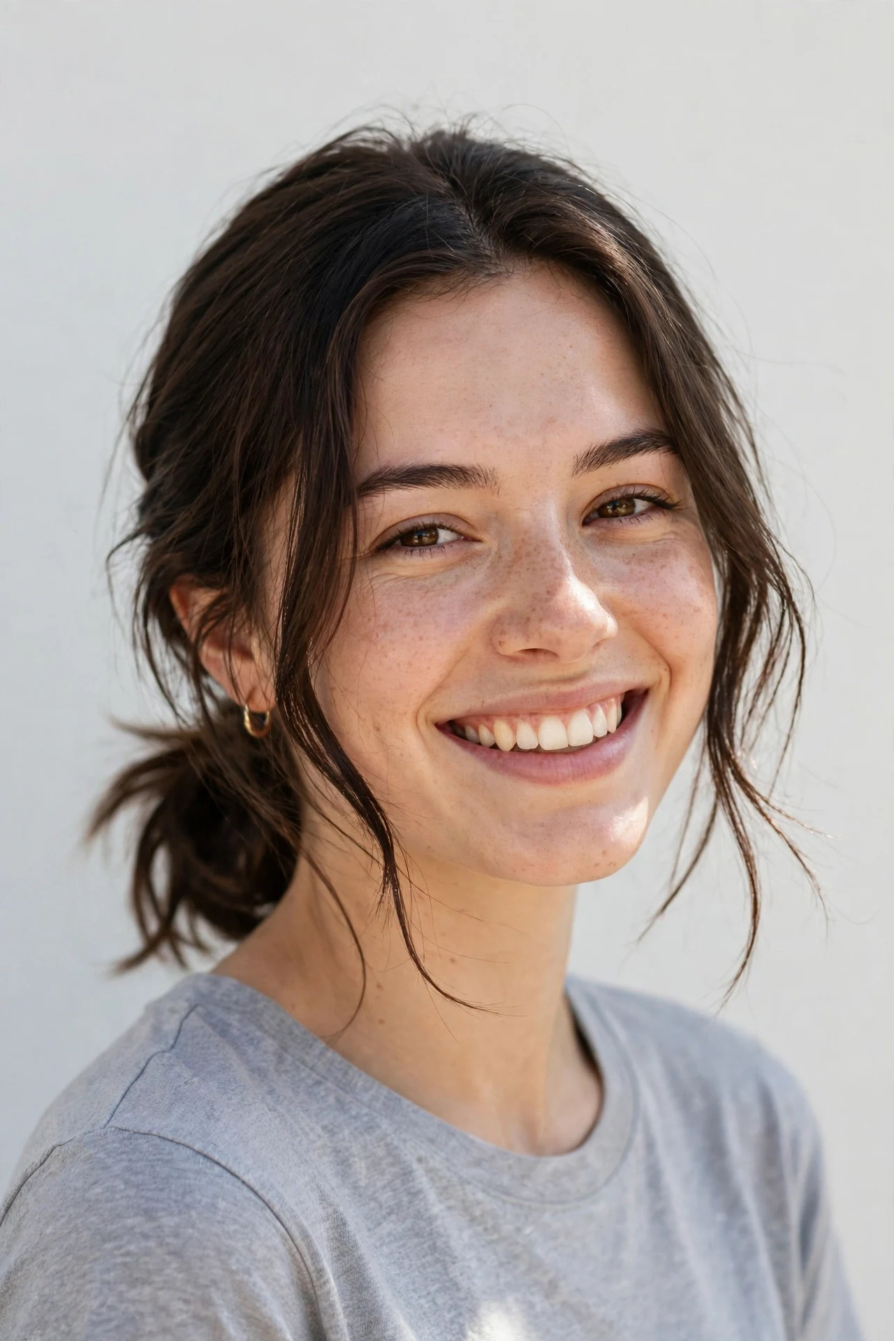 Collarbone bob worn in a low loose ponytail with face framing pieces