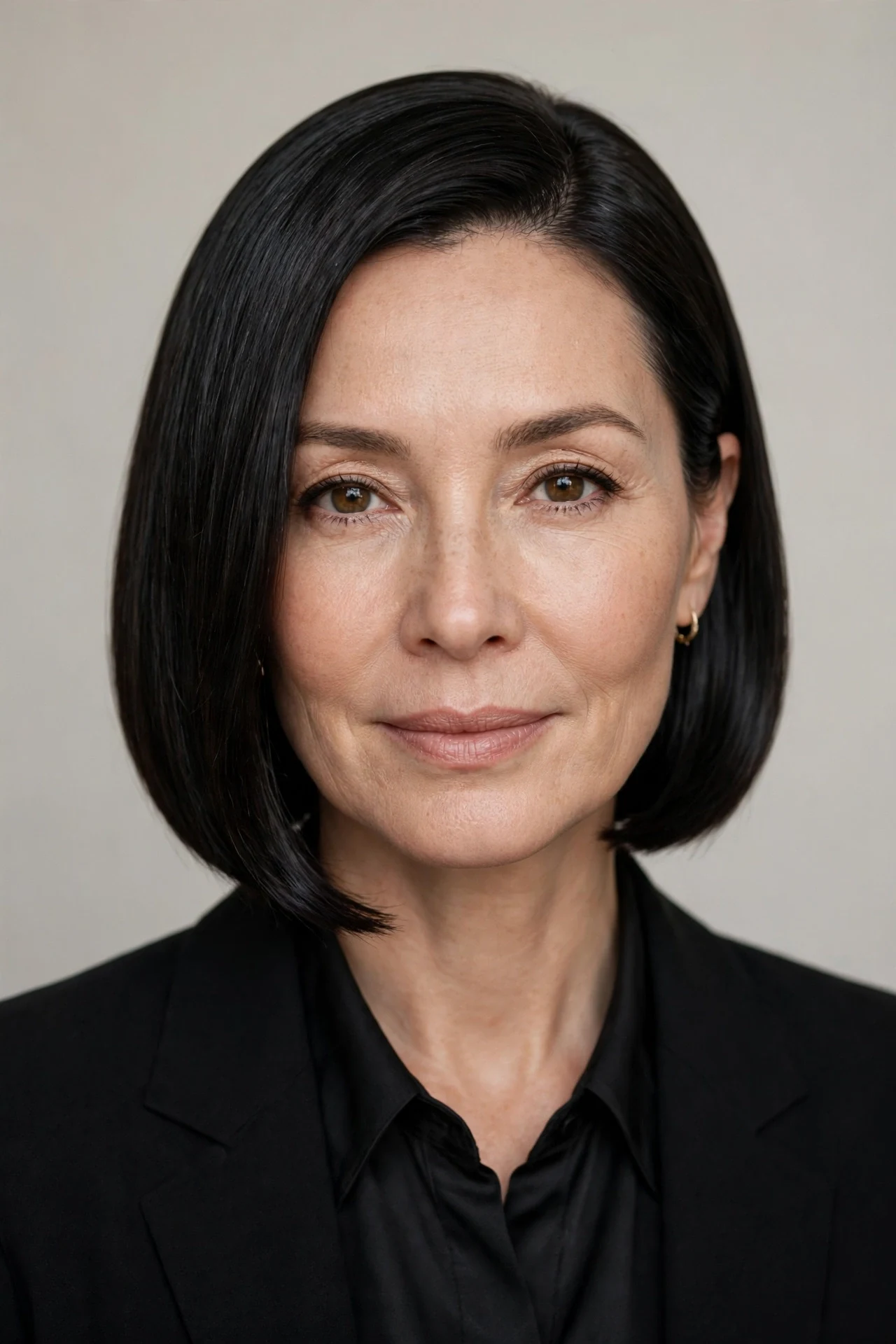 Sleek glass hair bob with mirror shine on a woman with black hair