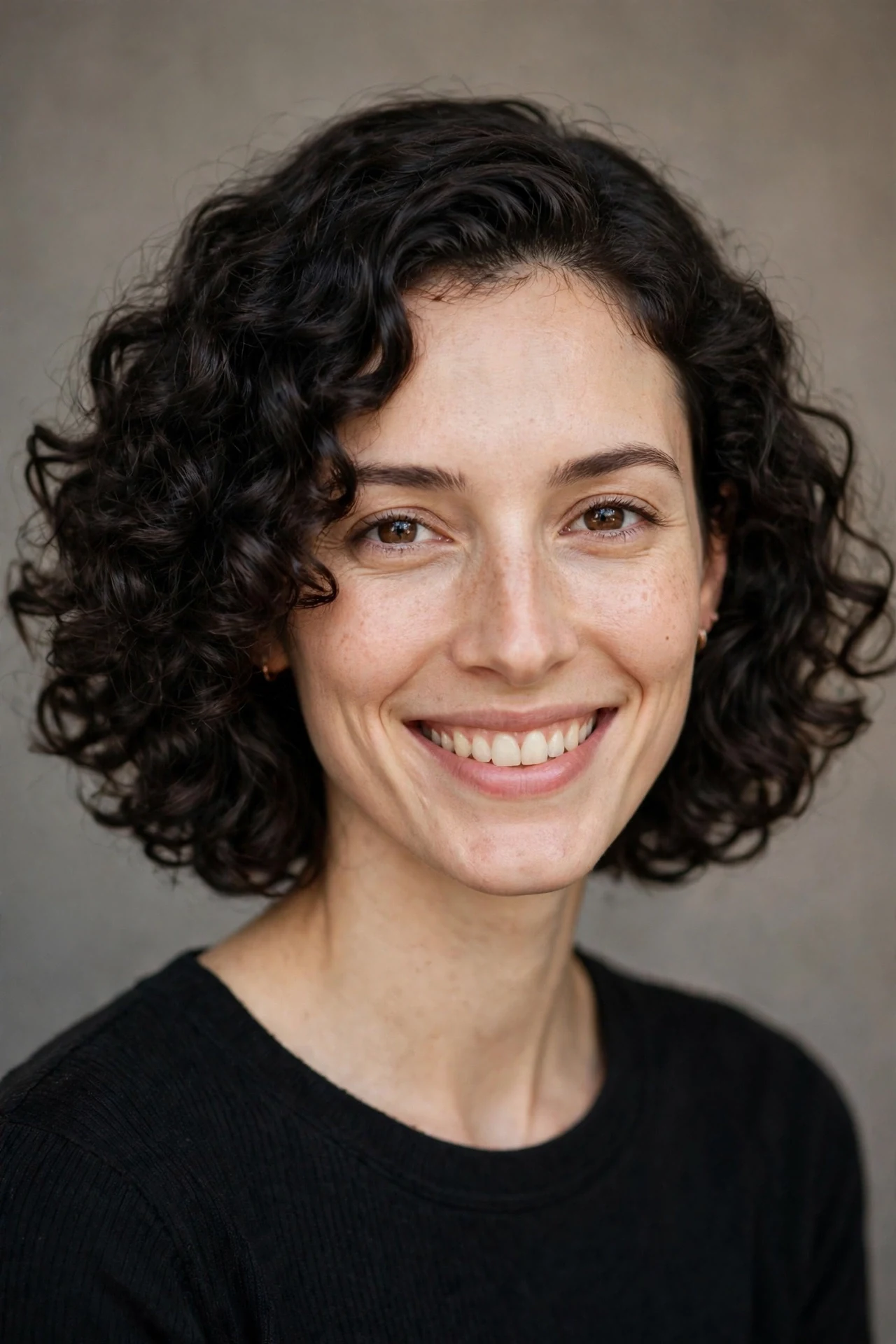 Curly chin-length lob with a side part on a long face