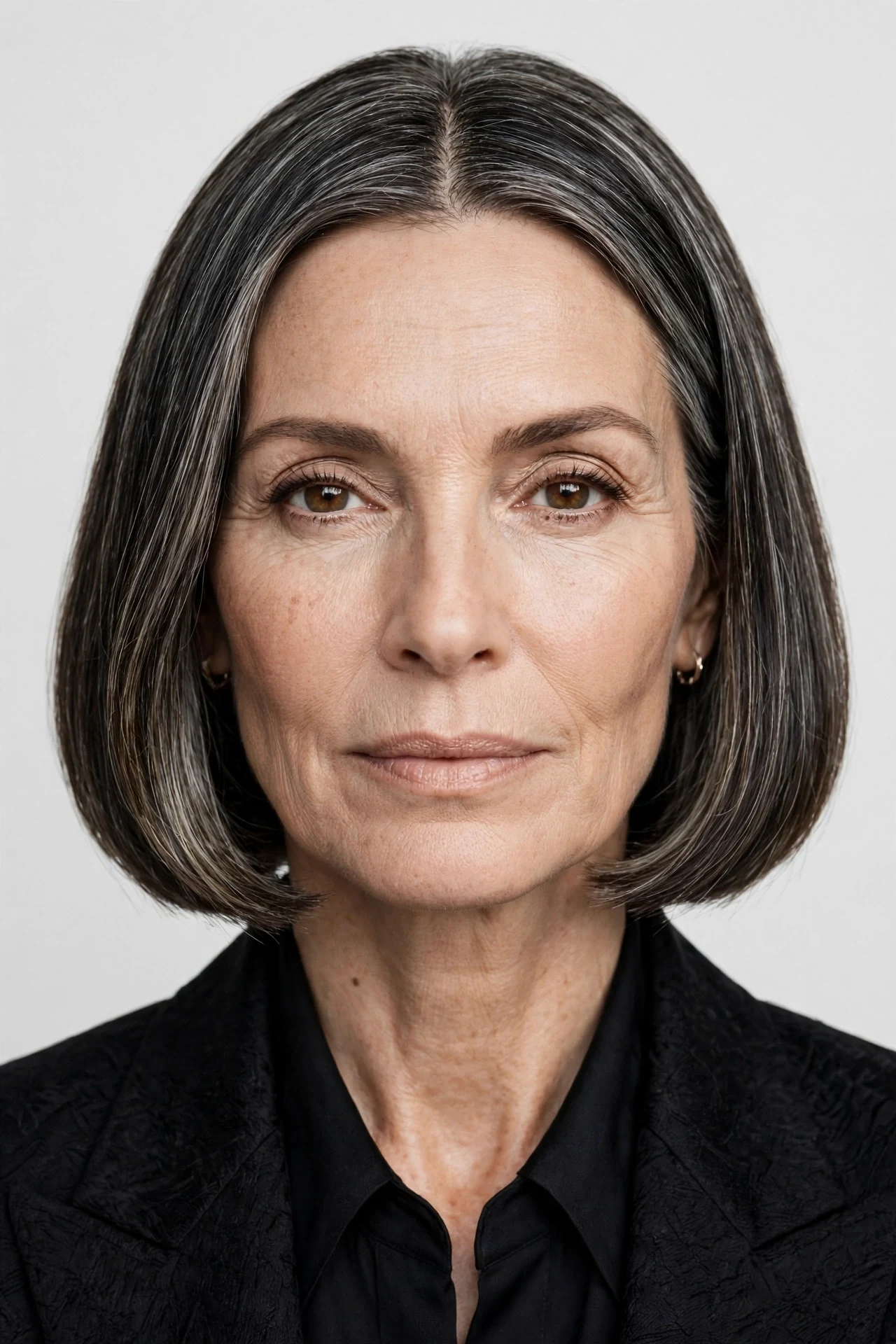Middle part bob for women over 50 with silver streaked hair