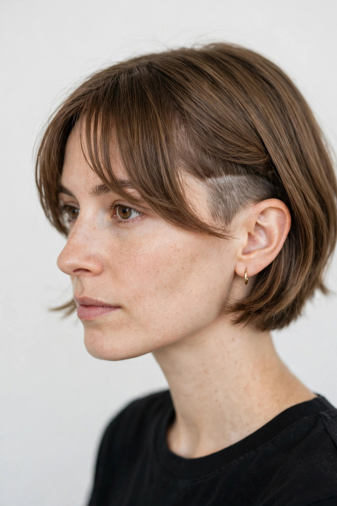 Undercut bob with curtain bangs and a side undercut revealed at the temple